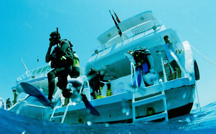 Scuba diver jumping off a boat