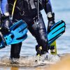 Top 5 Hot Summer Items From Your Local Scuba Store scuba diver walking with gear and dive accessories